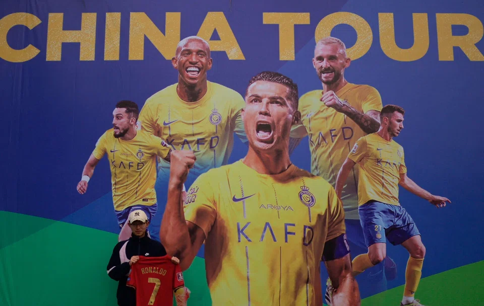 A Ronaldo fan posing for a picture prior to a training session in Shenzhen. Al Nassr Football Club has apologised for the cancellation of two matches due to the football superstar's injury.