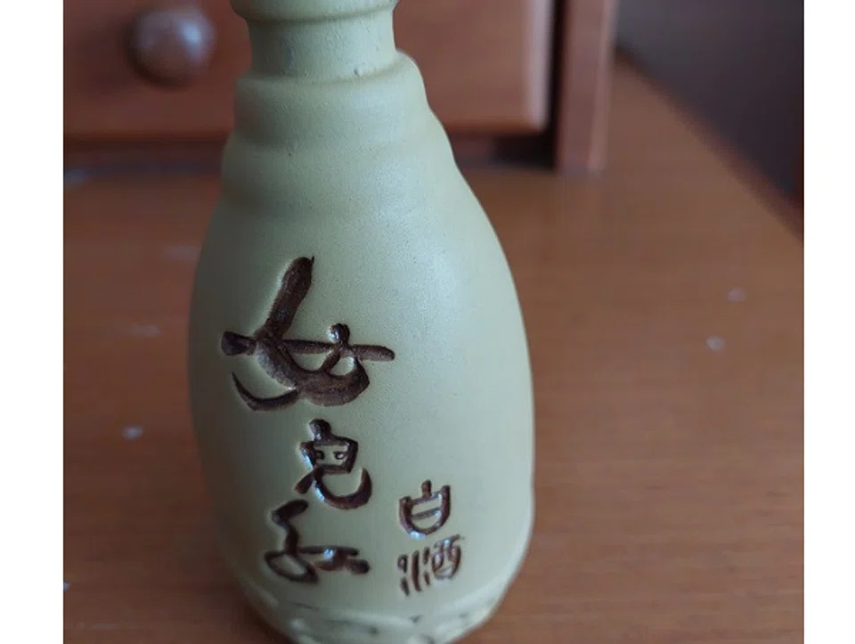 The sight of Chinese wine being sold in small clay bottles by a hawker moved this writer to compose a poem.