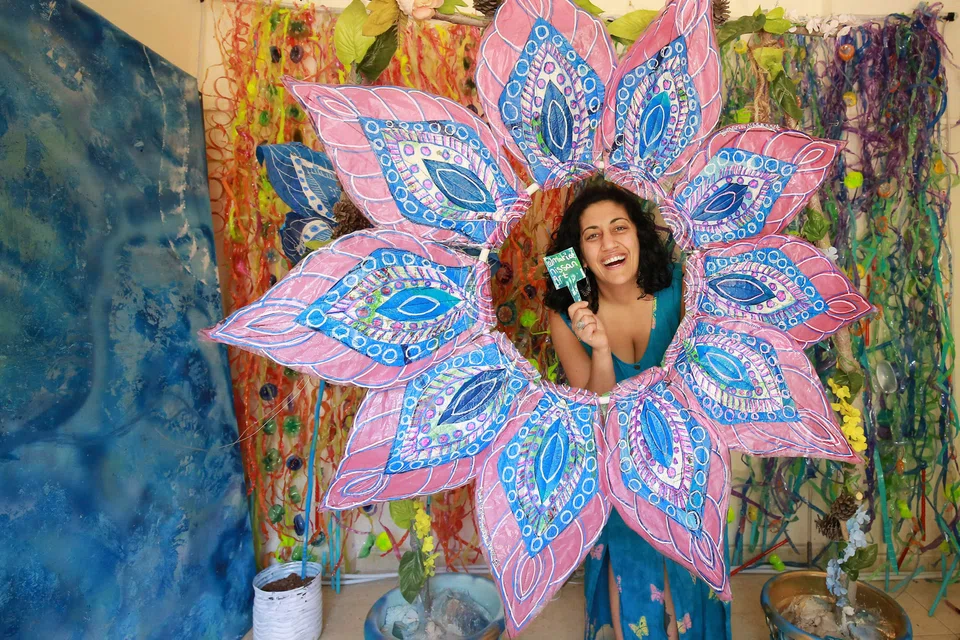 Maria Nissan, an environmental activist and artist, with an installation made from plastic waste collected from the streets, in Amman; Nissan's art is often collages themed on women’s faces, flowers and Oriental motifs.