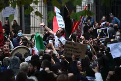 People take part in a demonstration in support of Iranian protesters in Paris, on Sept 25, 2022. 