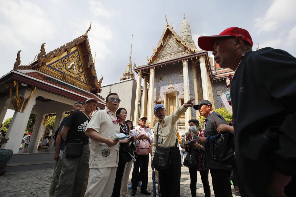 Chinese tourists at the Temple of the Emerald Buddha at the Grand Palace complex in Bangkok. China and Thailand have permanently waived visa requirements for each other's citizens.