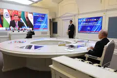 A pool photograph from Russian state agency Sputnik shows Russia's President Vladimir Putin at a virtual summit of the BRICS group of nations (Brazil, Russia, India, China and South Africa) to discuss the Israel-Hamas war, in Moscow on Tuesday (Nov 21.  