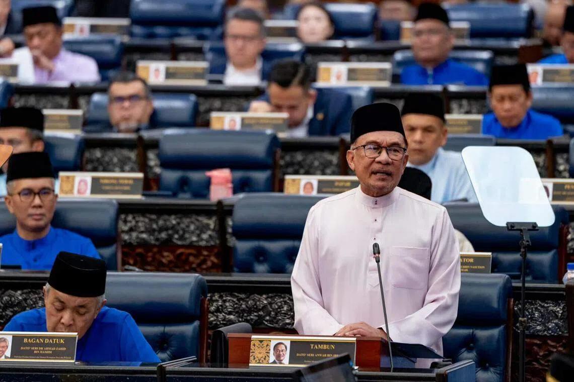The Bersatu party, which leads the opposition alliance, found that four lawmakers were getting threatened with legal action or offered cash bribes to back Prime Minister Anwar Ibrahim (top).