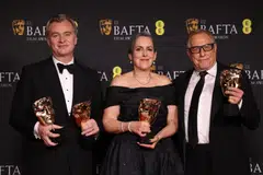 Christopher Nolan, winner of the awards for Director and Best Film for "Oppenheimer" and producers Charles Roven and Emma Thomas, at the 2024 British Academy of Film and Television Awards in London, Britain, Feb 18, 2024. 