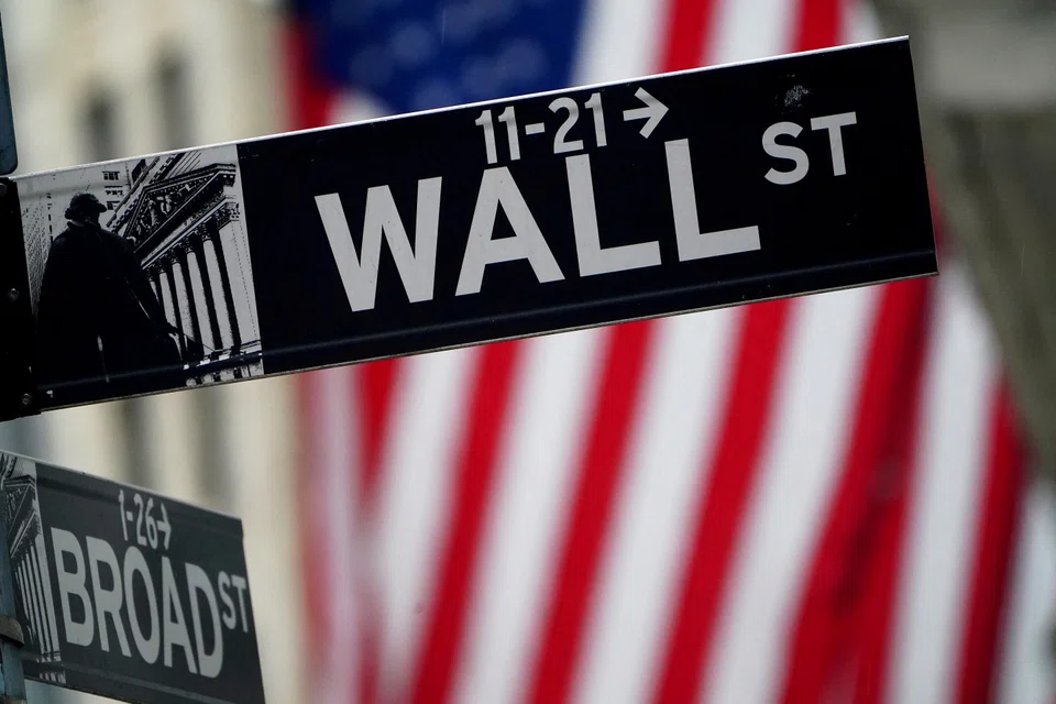 FILE PHOTO: A Wall Street sign outside the New York Stock Exchange in New York City, New York, U.S., October 2, 2020. REUTERS/Carlo Allegri/File Photo/File Photo/File Photo