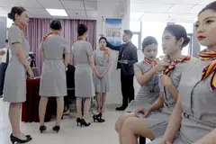 An applicant is measured for height during a recruiting session for cabin crew jobs at Hainan Airlines in Beijing, China, March 30, 2023. 