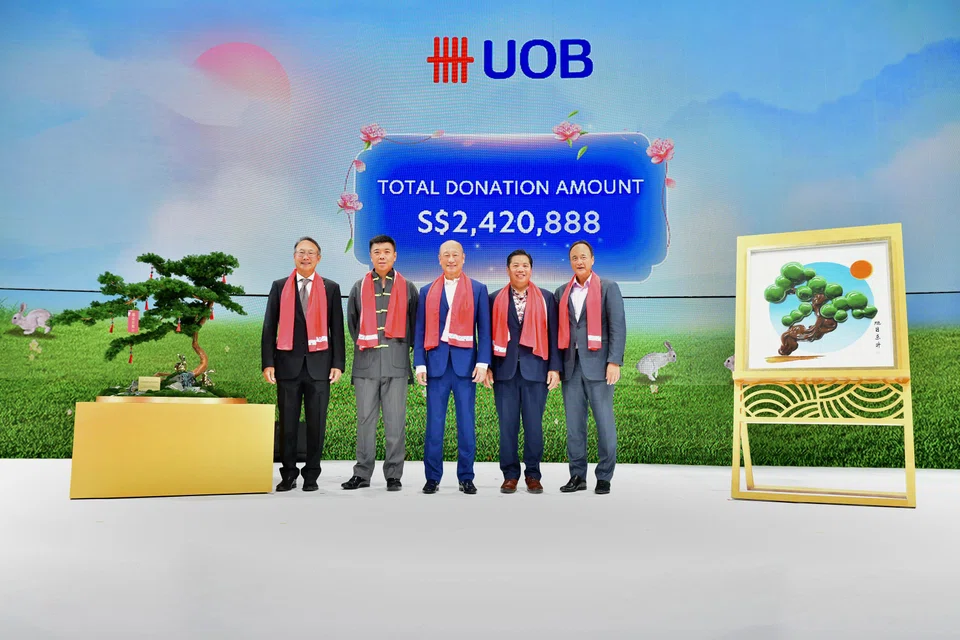 UOB chief executive officer Wee Ee Cheong (centre) with winning bidders Kelvin Lim (second from left) and Neo Kah Kiat (second from right), as well as UOB head of group commercial banking Eric Lian (extreme left) and head of group wholesale banking and markets Frederick Chin at the Lunar New Year fundraising gala dinner.