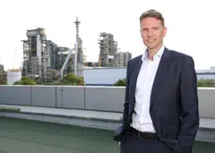 Matti Lehmus, Neste's chief executive, says the SAF plant in Singapore (in the background) is able to support a number of different markets, including the European and American markets.