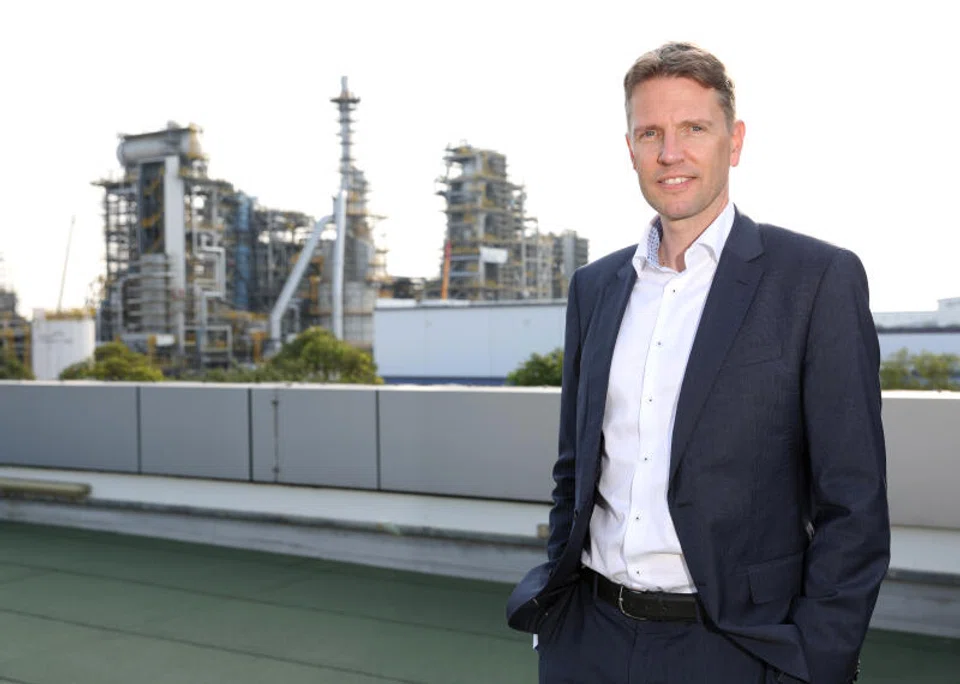 Matti Lehmus, Neste's chief executive, says the SAF plant in Singapore (in the background) is able to support a number of different markets, including the European and American markets.