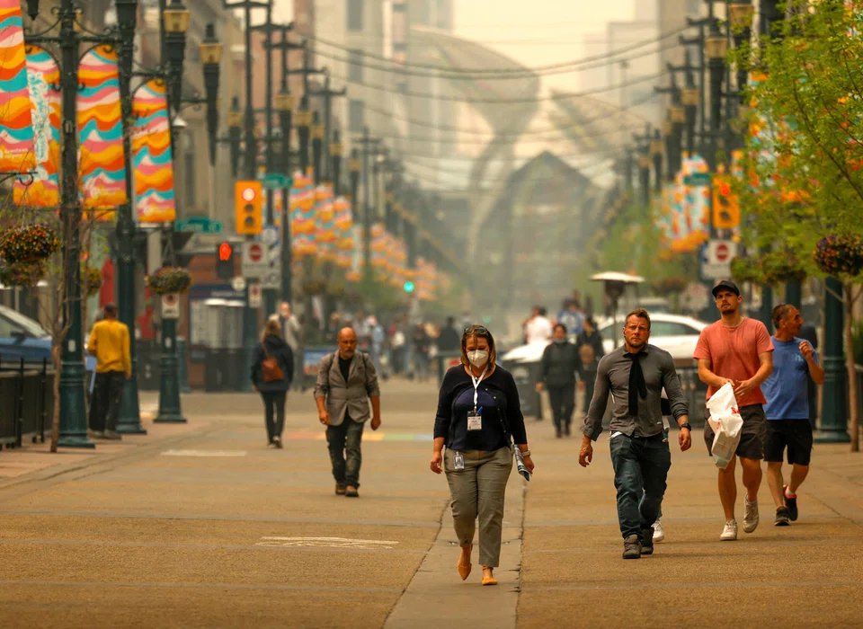 People walk as some 90 wildfires are active in Alberta, with 23 out of control, according to the provincial government, in Calgary, Alberta, Canada May 16, 2023.  REUTERS/Leah Hennel