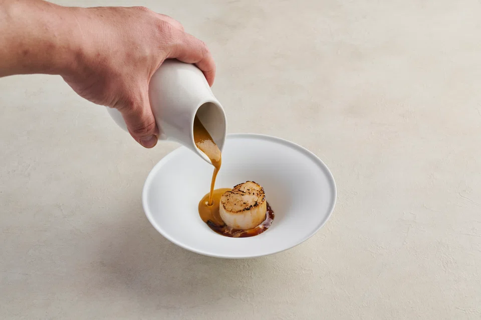 Slow-cooked scallop on a bed of liliy bud puree, tamarind glaze and ginger-tomato sauce.