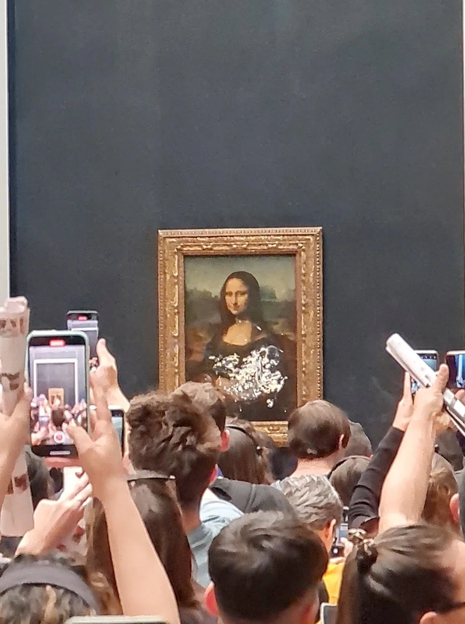 Cake was smeared on the protective glass surrounding the famous Mona Lisa painting at the Louvre Museum in Paris on Sunday. A sea of cellphones went up to record the cleanup.   

