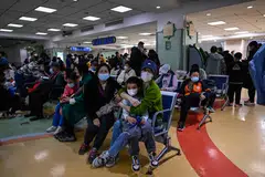 Children and their parents wait at an outpatient area at a children hospital in Beijing. China is grappling with a spike in respiratory illnesses as it enters its first full winter season since it lifted strict Covid-19 restrictions in December.