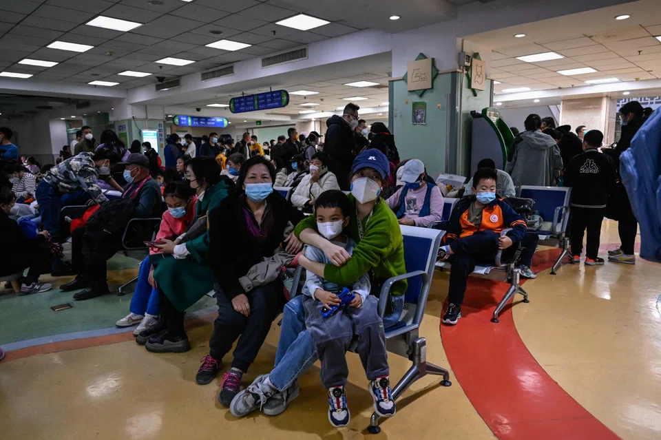 Children and their parents wait at an outpatient area at a children hospital in Beijing. China is grappling with a spike in respiratory illnesses as it enters its first full winter season since it lifted strict Covid-19 restrictions in December.