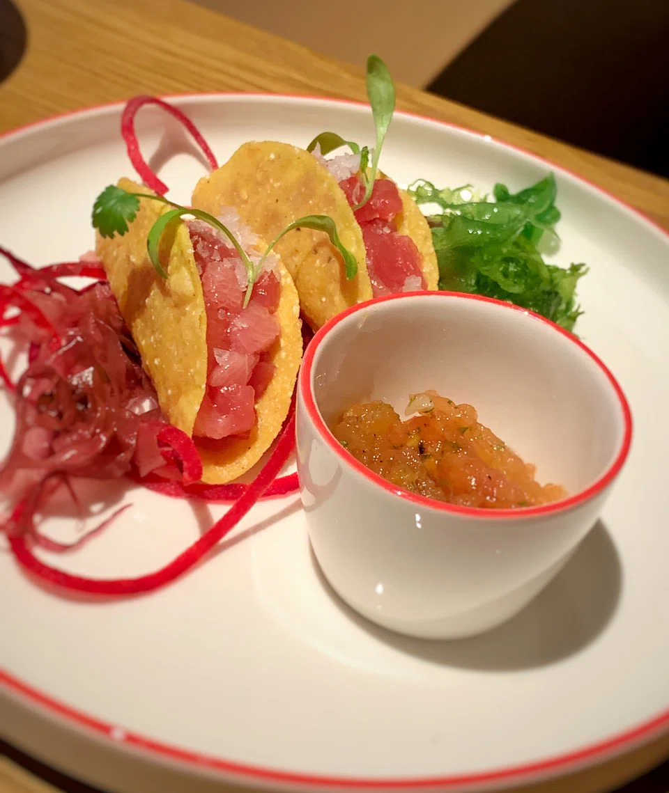 Corn tortillas filled with chopped tuna.