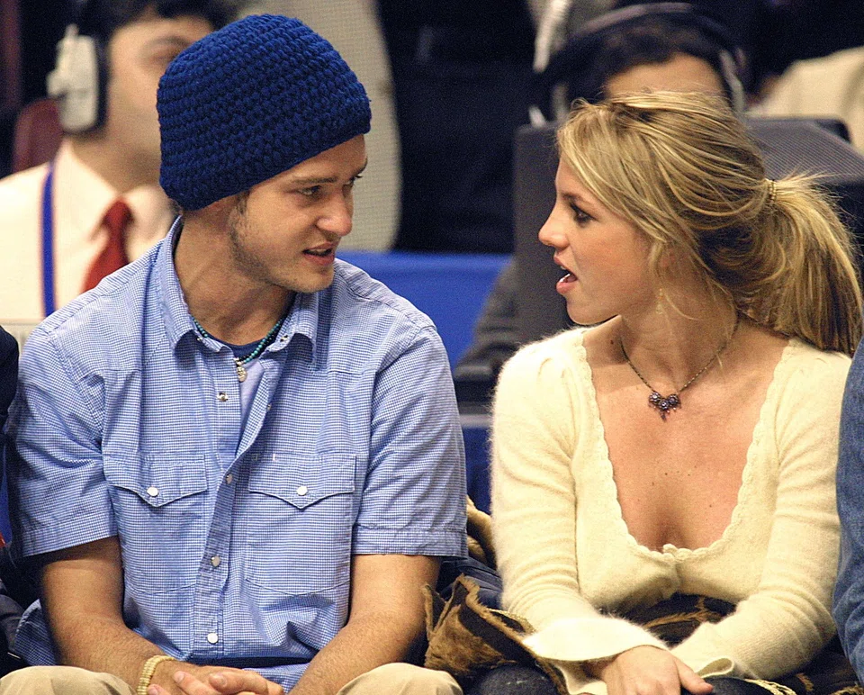 Pop superstars Britney Spears (R) and then boyfriend Justin Timberlake (L)  at the NBA All-Star Game on 10 Feb 2002 in Philadelphia. Britney Spears says in her eagerly anticipated new memoir that she had an abortion during her relationship with Justin Timberlake more than two decades ago.