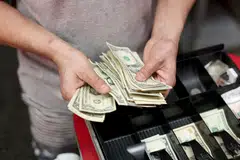 (FILES) In this file photo taken on January 12, 2022, Edwin Lopez sorts the money in the cash register at Frankie's Pizza in Miami, Florida. - As prices have surged, inflation has soared as a worry for global executives, overtaking concerns about Covid-19 disruptions in some regions, according to a survey released January 13, 2022. (Photo by JOE RAEDLE / GETTY IMAGES NORTH AMERICA / AFP)##########inflate10##########