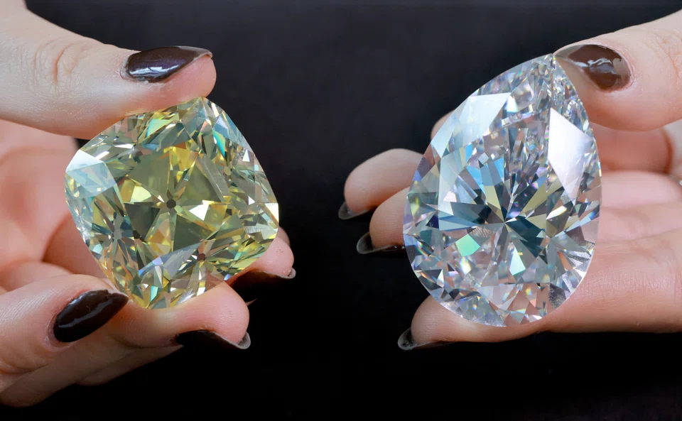 Returning for the third time since its mining in 1901, the 'Red Cross', (left) a fancy intense yellow, cushion-shaped 205.07 carat diamond and a 228.31 carat white diamond called 'The Rock' (right).