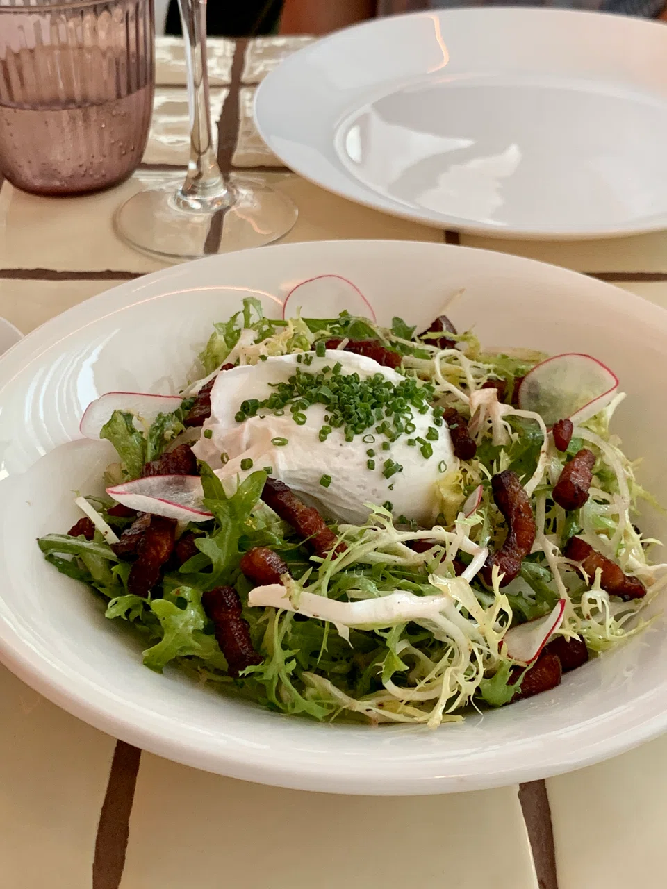 Curly greens, bacon and poached egg in the frisee lardon salad.