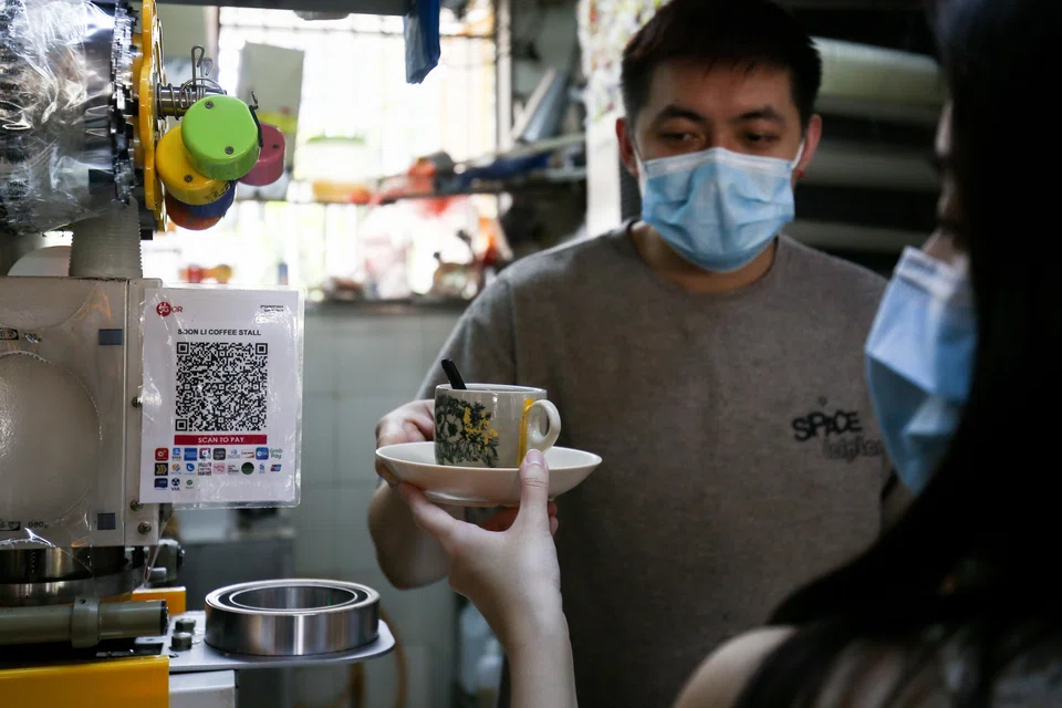 Soon Li Coffee Stall in Tiong Bahru market displaying the SGQR code for quick, cashless payments. Stalls like this are on board the subsidised meals programme by DBS/POSB. 
