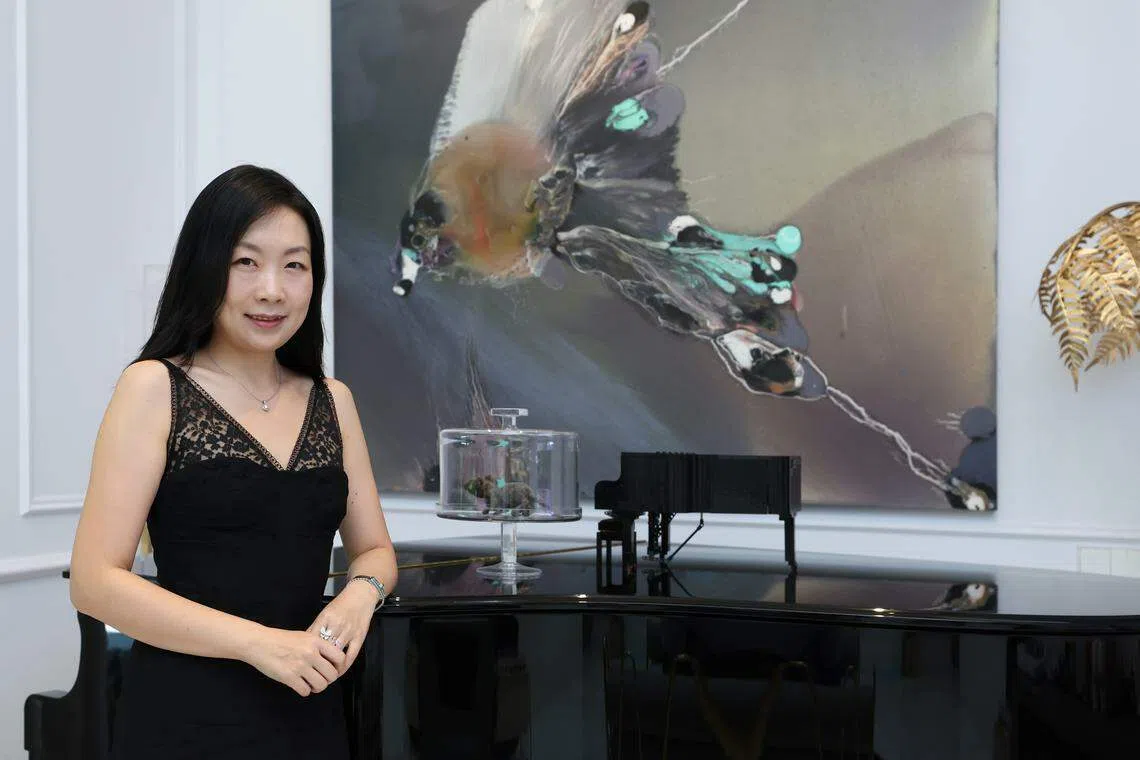 Art collector Lulu Sun, in front of a painting by Lionel Sabatte.