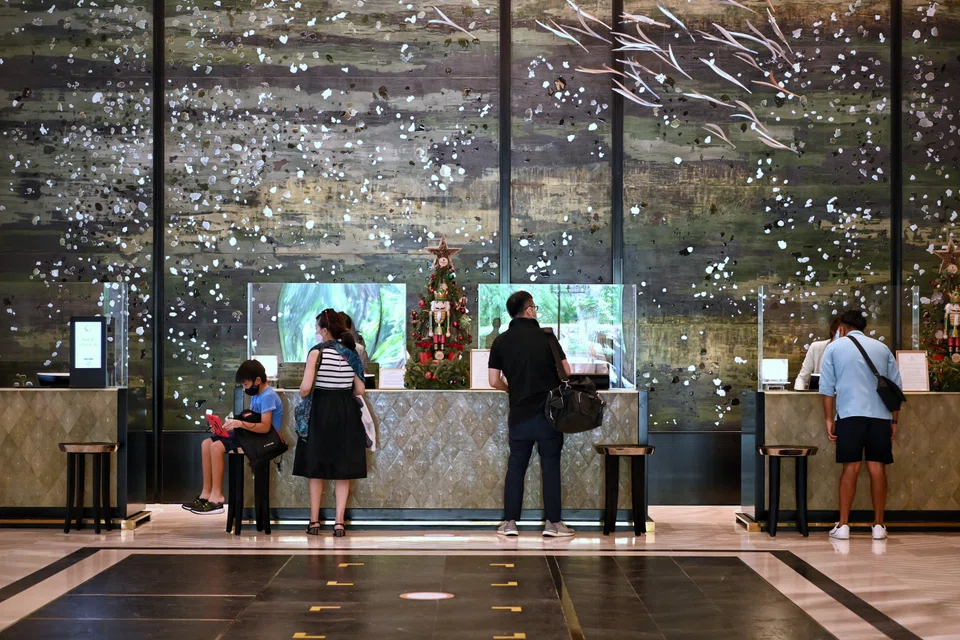 Hotel guests checking in for a staycation at the Shangri-La hotel last December.  Shangri-La Asia said that the recovery of its hotel business was strong in markets where travel restrictions have relaxed. This includes its markets in the United Kingdom, Turkey, the Philippines, Singapore and Malaysia. 