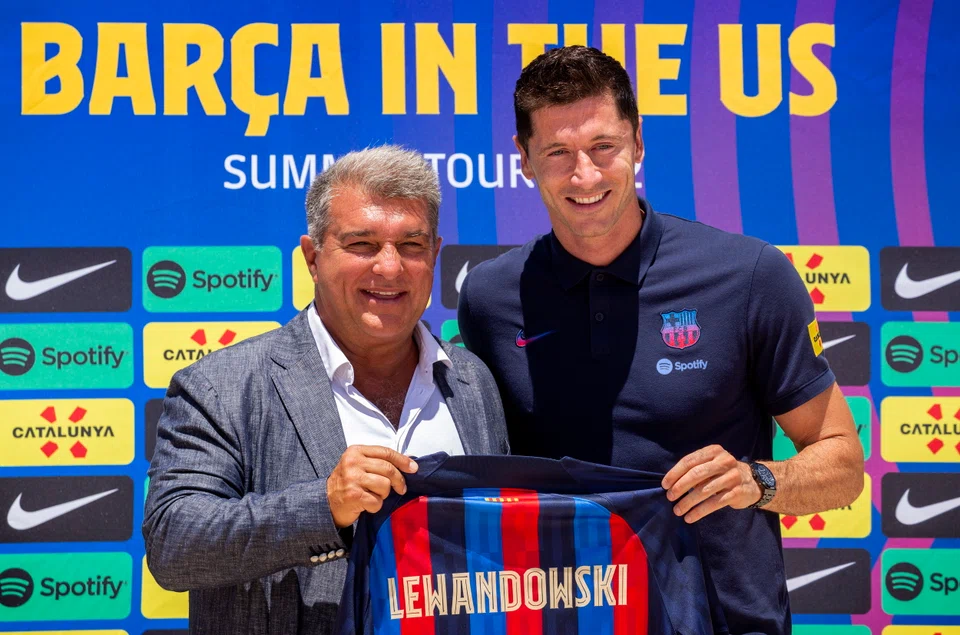 Barcelona's new striker Robert Lewandowski (right) with club president Joan Laporta at a press conference in the United States. Barcelona plays arch-rivals Real Madrid in Las Vegas on Saturday night.