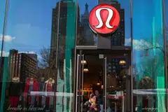 FILE PHOTO: A shopper walks out of the Lululemon Athletica store in New York, December 16, 2013.  REUTERS/Shannon Stapleton  (UNITED STATES - Tags: BUSINESS FASHION TEXTILE)/File Photo