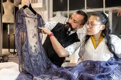 French fashion designer Julien Fournie (left) working on an embroidered dress at his studio