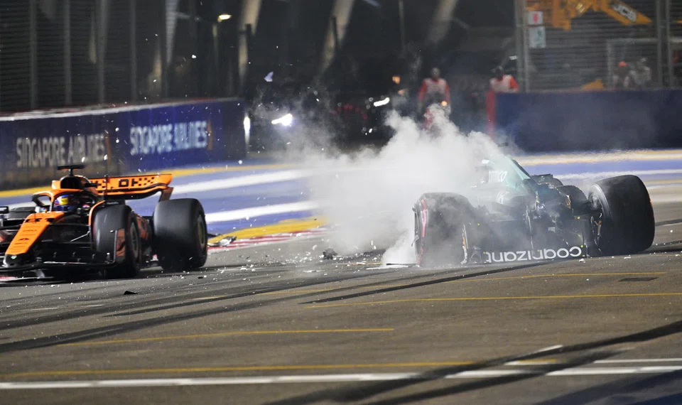 The remains of Stroll's Aston Martin, with him in the cockpit, bounced back onto the track to be narrowly avoided by the McLaren of Lando Norris.