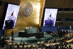 An image of 'Brave Commander,' the first ship to sail from Ukraine to the horn of Africa carrying grain supplies, is shown on screen as UN Secretary General Antonio Guterres speaks at the 77th General Debate at the UN headquarters in New York, Sept 20, 2022.  
