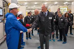 Bruno Le Maire, France's finance minister, meets employees on a production line at the inauguration of the Automotive Cells Company (ACC) gigafactory in Douvrin, France, on Tuesday (May 30). 