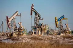 Oil pumping jacks, also known as "nodding donkeys", in an oilfield near in Russia. Russia, seeking to nudge up global oil prices in concert with Saudi Arabia, will reduce its oil exports by 500,000 bpd in August 