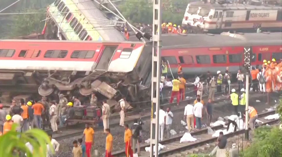 Rescue workers and police officers work next to mangled train carriages, following a deadly collision of two trains, in Balasore, India June 2, 2023, in this still image obtained from a video. ANI/Reuters TV via REUTERS THIS IMAGE HAS BEEN SUPPLIED BY A THIRD PARTY. NO RESALES. NO ARCHIVES INDIA OUT. NO COMMERCIAL OR EDITORIAL SALES IN INDIA