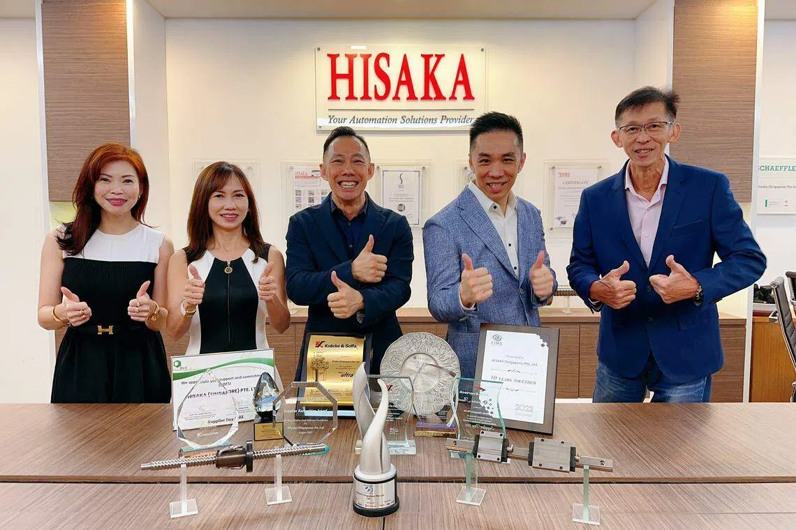 The management of Hisaka (Singapore) with awards that the company has won. (L-R) Director of finance and IT Jessica Ong; director of office and administration Joanna Tan; managing director Anthony Cheng; director of business strategy Jackie Cheng; and director of operations Andy Yong.