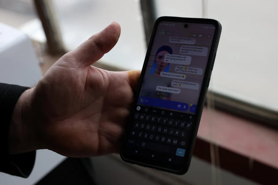 Travis Butterworth, an artisan leather shop owner whose AI chat partner is Lily Rose, shows the Replika app on his phone at his shop in Denver, Colorado, March 7, 2023.   