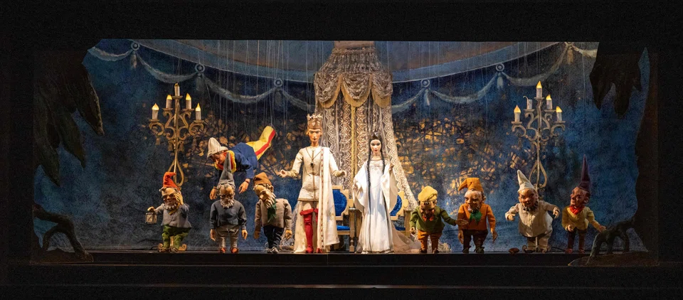 Puppets of the Snow White fairytale puppet show on stage; most puppets have at least 11 strings, so the puppeteer can make them “kiss each other, hug each other, hit each other, (or) whatever we want”, says Edouard Funck, a puppeteer.