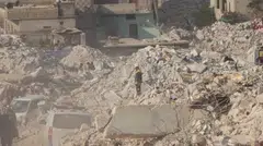 A White Helmet volunteer stands among rubble, in the aftermath of a deadly earthquake, in Harem, Idlib, Syria, Feb 10, 2023. 