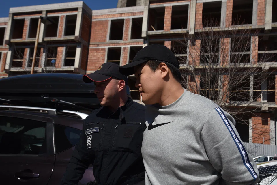 Police officers escort South Korean crypto mogul Do Kwo in Podgorica, Montenegro.