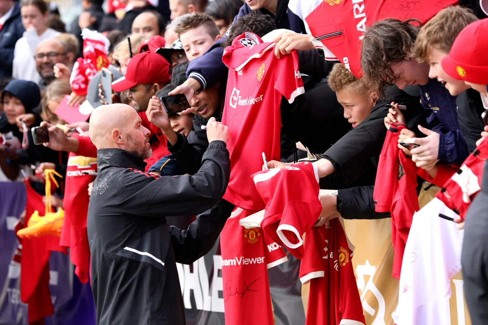Manchester United manager Erik ten Hag signs autographs for fans after a training session in Perth during the team's pre-season tour in July. The Dutchman faces a difficult first season at Old Trafford. 