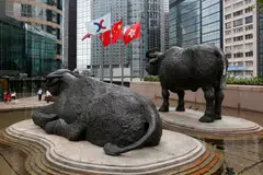Hong Kong stocks such as Alibaba and Tencent are among the 24 stocks which will be priced and traded in both yuan and the Hong Kong dollar under the Dual Counter Model on the Hong Kong stock exchange (top) from Monday.