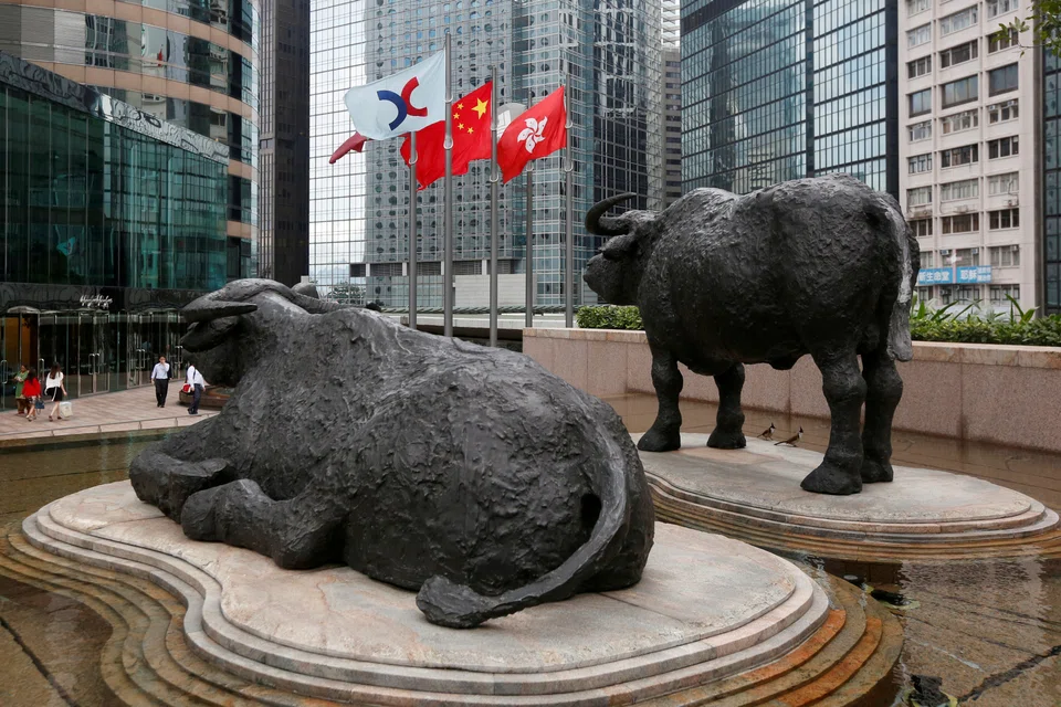 Hong Kong stocks such as Alibaba and Tencent are among the 24 stocks which will be priced and traded in both yuan and the Hong Kong dollar under the Dual Counter Model on the Hong Kong stock exchange (top) from Monday.