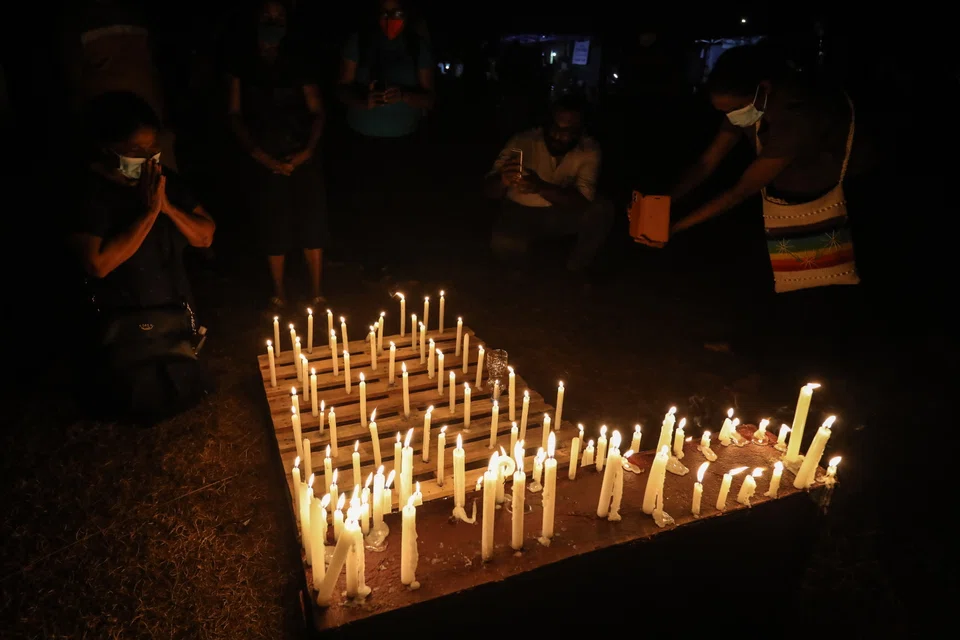Protesters light candles in memory of the protester killed in a police shooting during the clash in Rambukkana in front of the Presidential Secretariat in Colombo, Sri Lanka, 19 April 2022. 