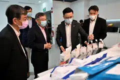 Dr Zhou Lihan, Co-founder and CEO of MiRXES showing a Covid-19 test kit to Mr Gan Kim Yong, Minister of Trade and Industry during his tour of the MiRXES Industry 4.0 Manufacturing Facility on May 27, 2022.