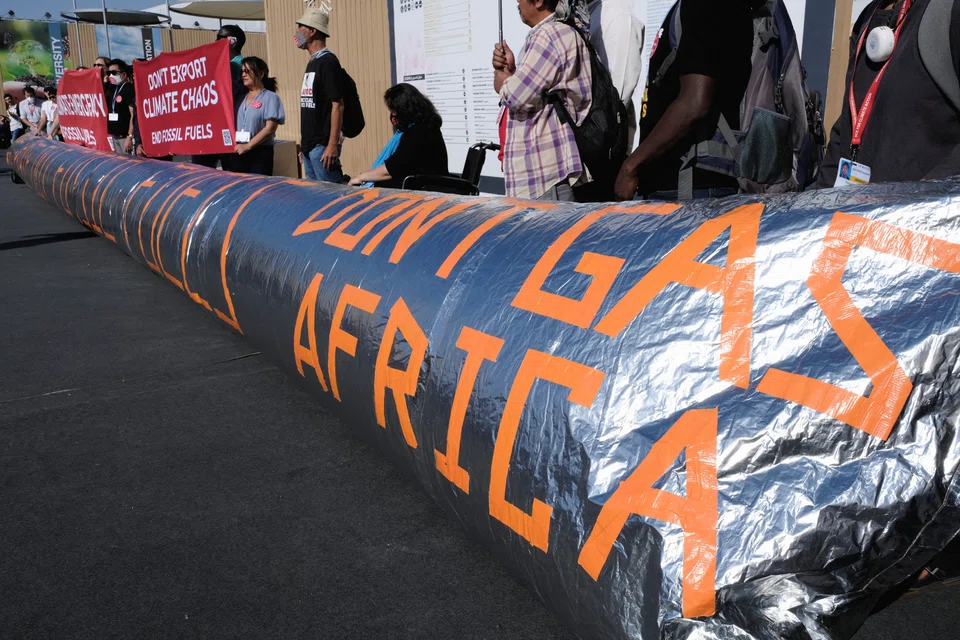 Activists holding a demonstration to implore countries to phase out all fossil fuels at the COP27 climate summit in the Red Sea resort of Sharm el-Sheikh, Egypt, on Friday (Nov 18).  Egypt is keeping a tight lid on demonstrations by requiring permits. 
