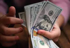 The dollar headed for a fourth week of gains while traders reduced their bets on how quickly the Bank of Japan might raise interest rates and how soon the Federal Reserve will cut them.