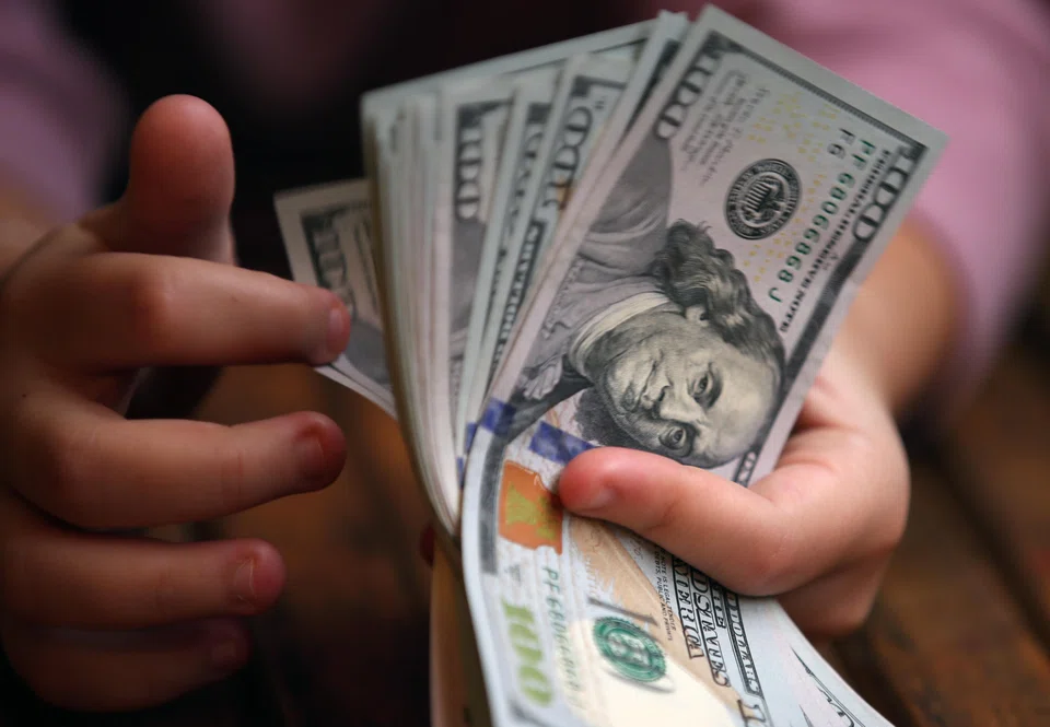 The dollar headed for a fourth week of gains while traders reduced their bets on how quickly the Bank of Japan might raise interest rates and how soon the Federal Reserve will cut them.