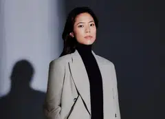 Photojournalist Nicole Tung in a double-breasted suit by Acne Studio, Net-a-Porter.
