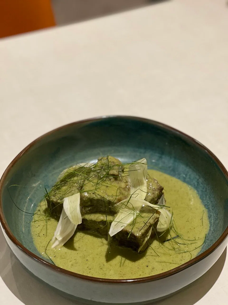 Fork-tender beef in green curry.