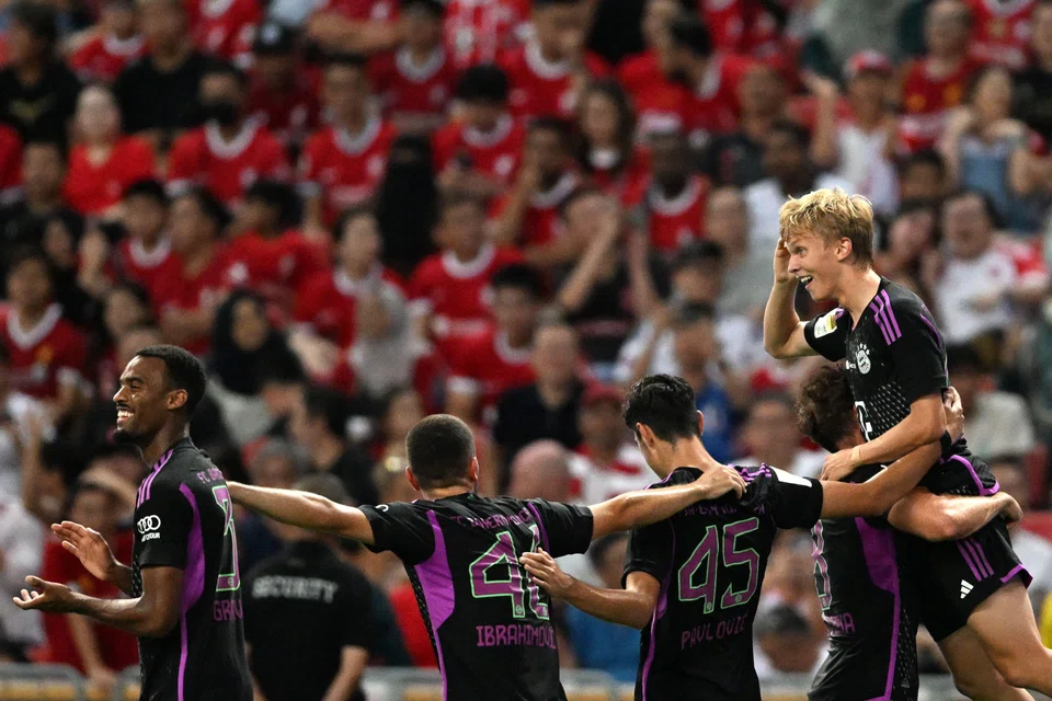 Bayern Munich's Frans Kratzig (right) celebrating after netting an injury-time winner against Liverpool at the National Stadium in Singapore on Aug 2.